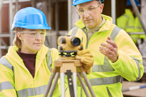 Apprentice using a theodolite